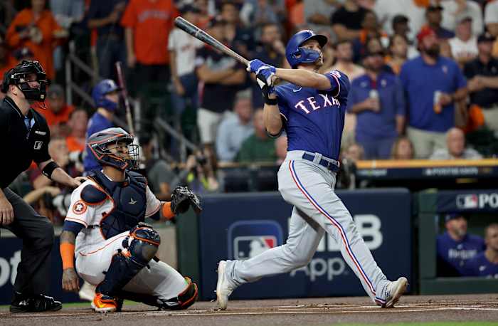 Texas Rangers shortstop Corey Seager hits a home run during the first inning of Game 7 of the ALCS against the Houston Astros at Minute Maid Park.